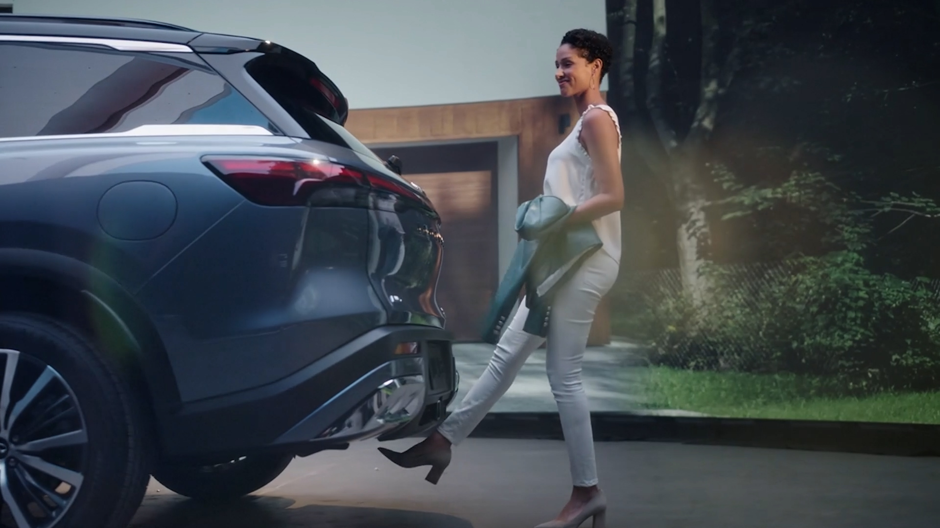 2023 INFINITI QX60 Crossover SUV parked with woman walking behind vehicle